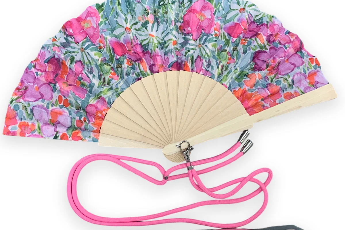 Floral folding fan with a pink neck cord.