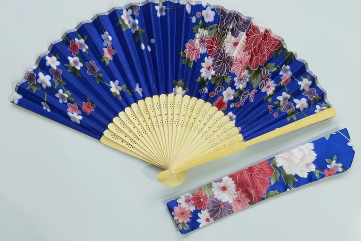 Blue floral folding fan with natural-colored ribs and a matching sleeve.
