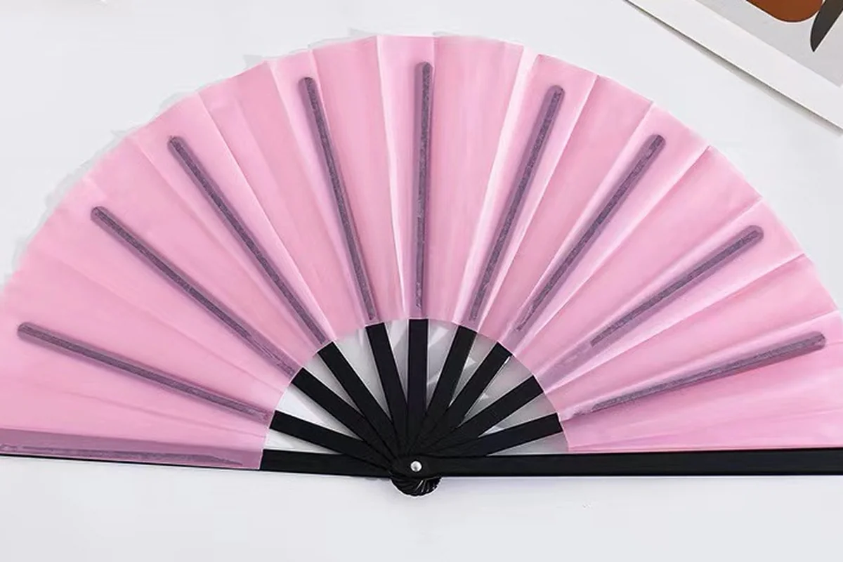 Pink folding fan with visible black supporting ribs.