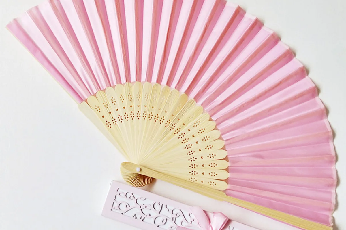 Pink folding fan with a decorated matching gift box.