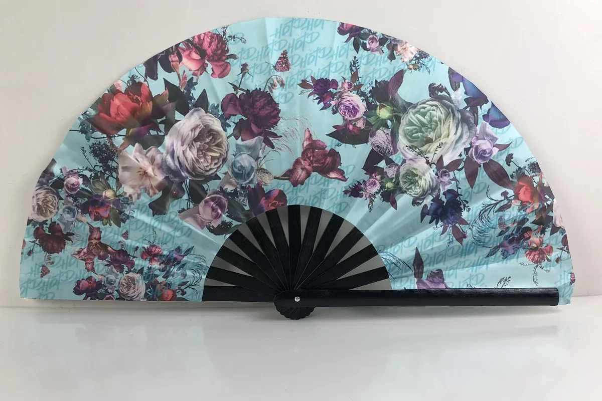 Folding fan with a colorful floral print and black ribs.