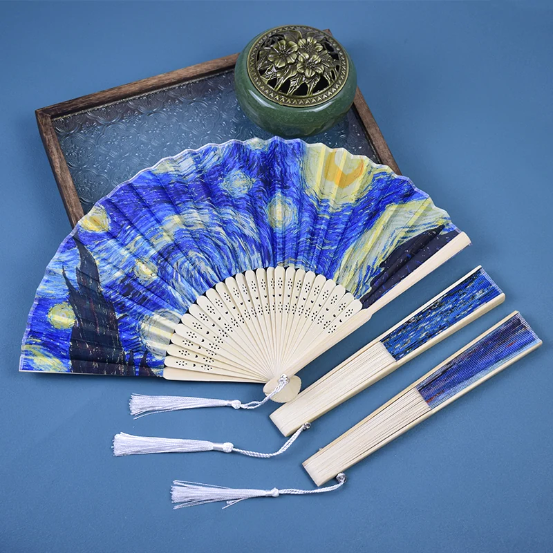 Blue and yellow art folding fans with pale frames and white tassels