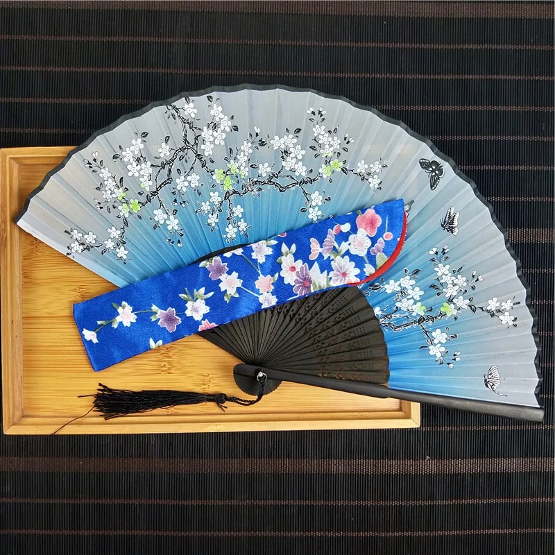 Blue blossom fan and printed sleeve arranged on a display tray