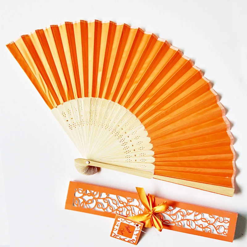 Orange folding fan with a matching decorative favor box and ribbon