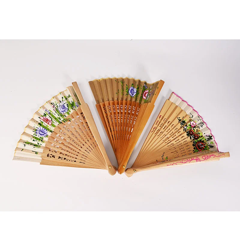 Three warm tone folding fans with floral decoration and cutwork ribs