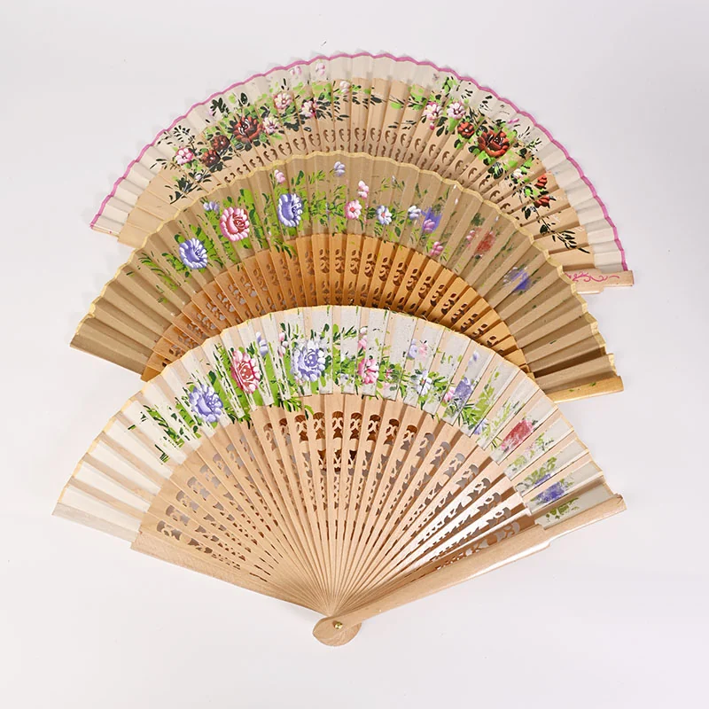 Partly open floral cutwork fans arranged to show their decorative edges