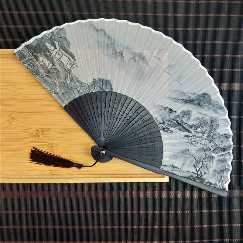 Gray landscape folding fan with a dark frame and tassel