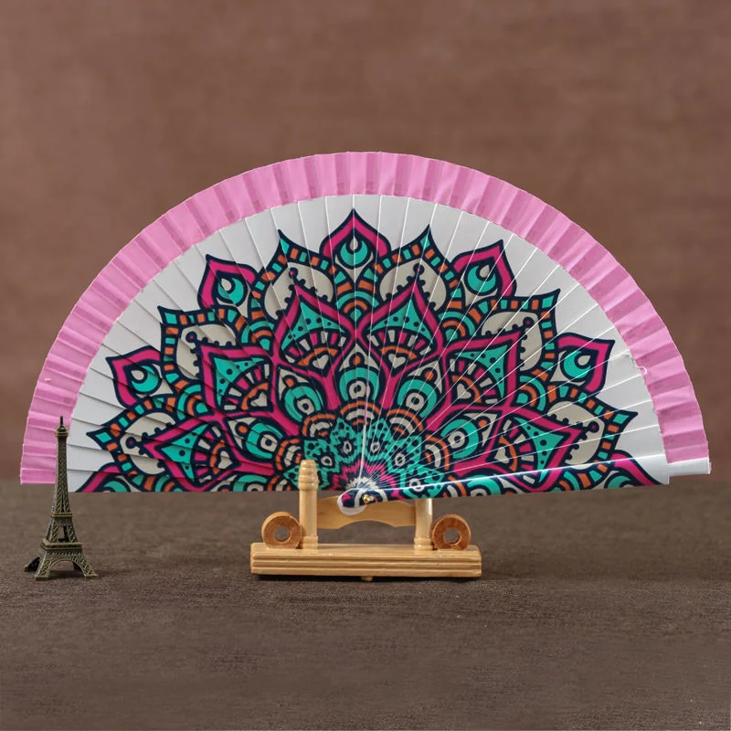 Pink folding fan with a multicolor mandala centered across the leaf