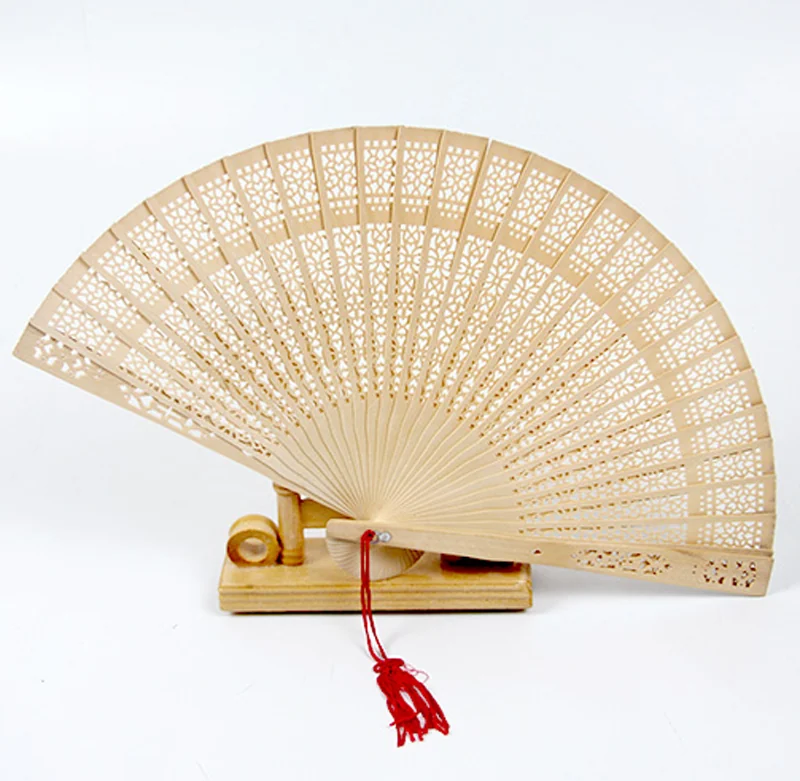 Natural tone lattice folding fan displayed on a stand with a red tassel