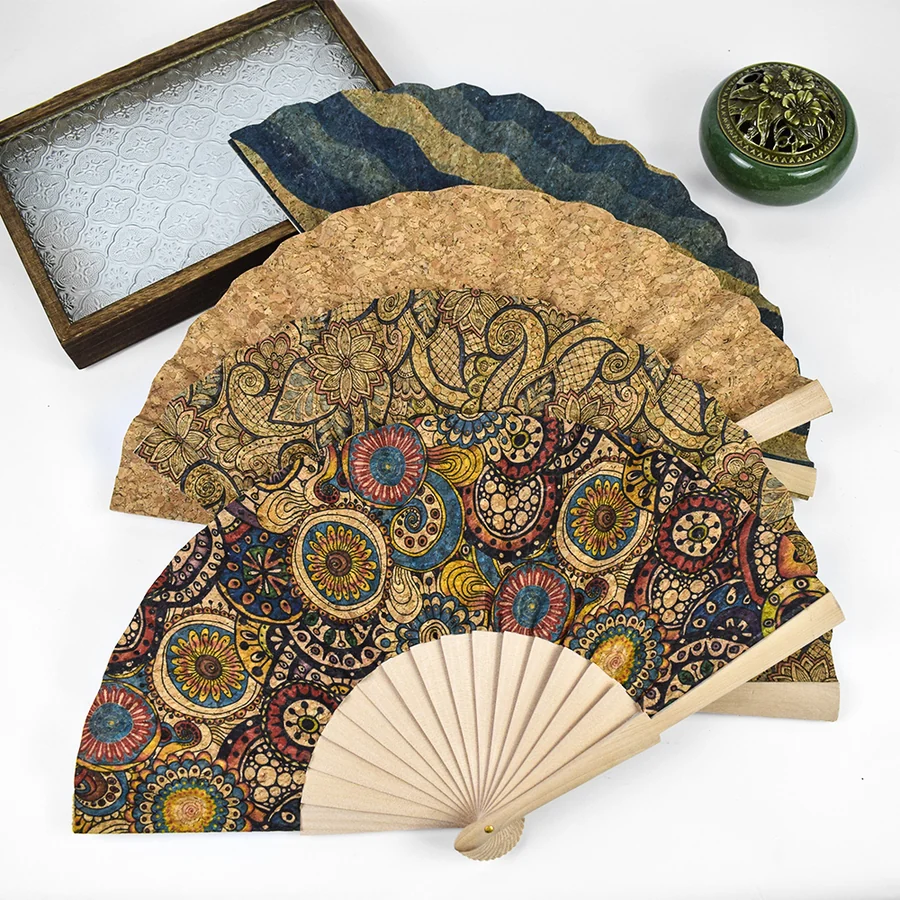 Decorative folding fans with warm ornamental patterns and pale ribs