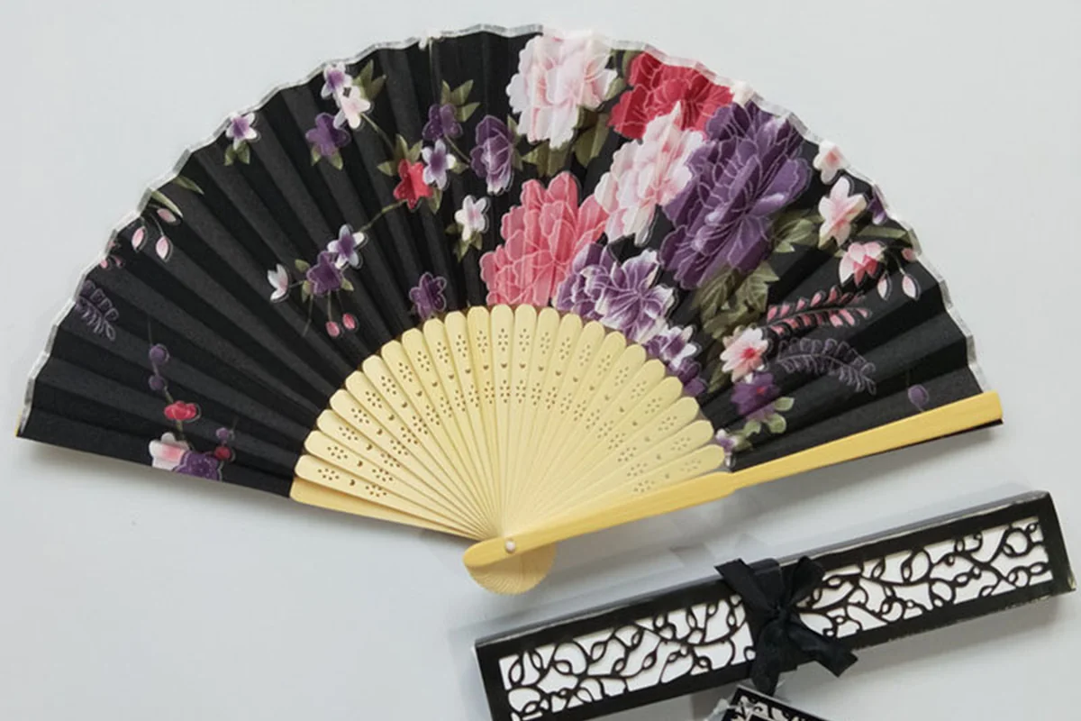 Black floral folding fan with a matching decorated gift box.